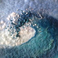 a close up view of some blue and white wool with bubbles on it's surface