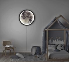 a child's room with a bed, rocking chair and night sky clock