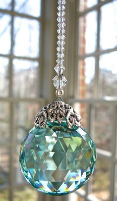 a glass ornament hanging from a window