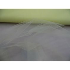 white tulle on top of a piece of yellow fabric with the bottom layer visible