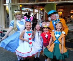 some people are dressed up as alice and the wonderland land characters in costume for halloween