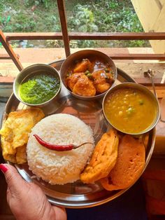 a silver plate topped with different types of food