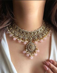 Adorn yourself in timeless elegance with this exquisite Light pink Kundan necklace set, perfect for weddings and special occasions. Crafted with meticulous attention to detail, the set features delicate pink and green hues reminiscent of Pakistani and Punjabi traditions, with a touch of Bollywood glamour. Complete with matching earrings and a stunning maangtika, this Indian Kundan ensemble effortlessly captures the essence of sophistication and grace. Measurements:   Necklace Length-15" Adjustable length with a golden zari dori at the back Width-9"   Earring Length- 2.5" Earring Width-1" Each earring weighs-15 gms  Maangtika Length- 6" Maangtika Width-1.2" Bridal Jewellery Pakistani, Light Pink Necklace, Indian Jewelry Set, Bollywood Glamour, Indian Jewelry Sets, Kundan Necklace, Bollywood Jewelry, Green Hues, Green Jewelry