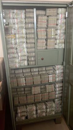 a large cabinet filled with lots of papers next to a wall covered in stacks of folders