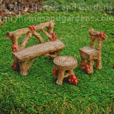 two wooden benches sitting on top of a green grass covered park bench next to a tree stump