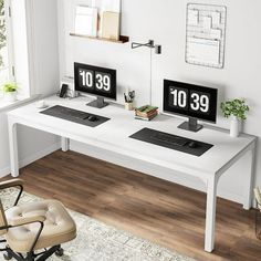 two computer monitors sitting on top of a white desk