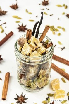 an assortment of spices in a glass jar with cinnamons, star anise and cloves