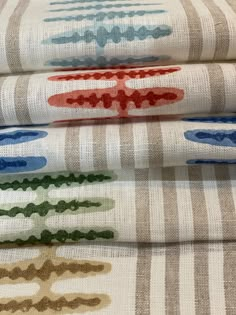 three different patterns on fabric, one is red and the other is blue with green