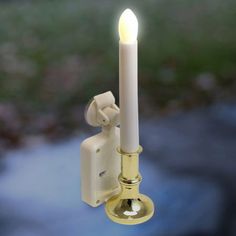 a white candle is lit on a wall