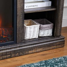 an open fireplace with baskets and books on the shelf next to it in a living room