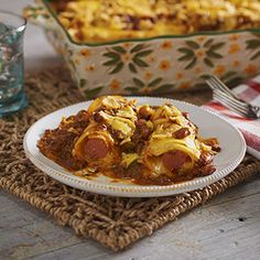 a white plate topped with food next to a casserole dish