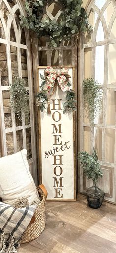 a sign that says home is in front of a window with a bow on it