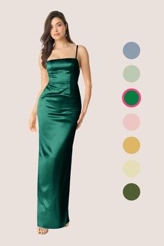 a woman in a long green dress standing next to color swatches on the wall