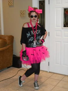 a woman in a pink tutu skirt and black shirt