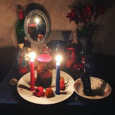 a table topped with plates covered in candles