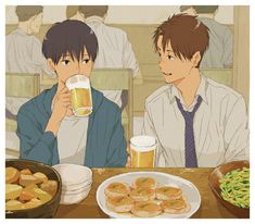 two people sitting at a table with food and drinks in front of them, one holding a beer