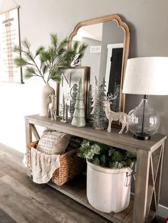 a wooden table topped with a mirror and christmas decorations