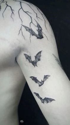 a man's arm with bats on it and lightning coming out of the back