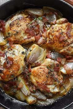 chicken with onions and herbs in a skillet