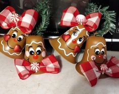 three gingerbread man ornaments sitting on top of a counter next to a microwave oven