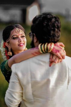 a bride hugging her groom on the forehead