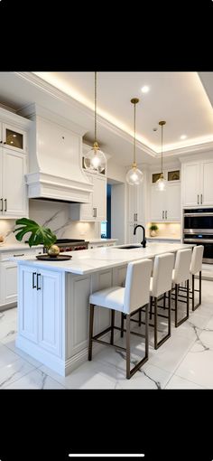 a large kitchen with white cabinets and marble counter tops, along with bar stools