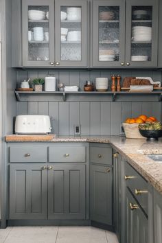 a kitchen with gray cabinets and counter tops