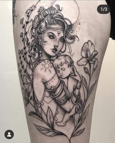 a woman holding a baby in her arms with flowers around her ankles and an arrow on the thigh