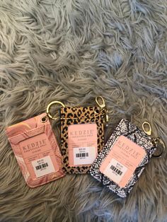 three small animal print bags sitting on top of a fur covered floor next to each other