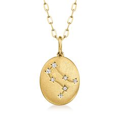 a gold zodiac necklace with diamonds on it