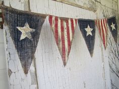 an american flag bunting hanging on the side of a building