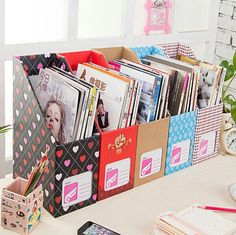 an organized desk with magazines and other items