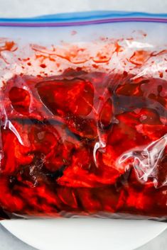 a bag filled with jelly sitting on top of a white plate