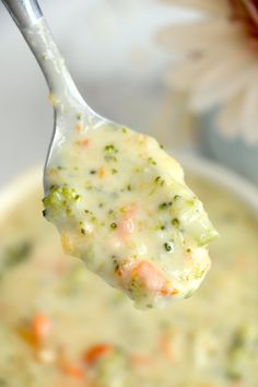 a spoon full of soup with broccoli and carrots