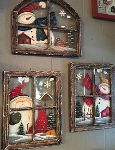 two framed snowmen are on the wall next to each other in an old window