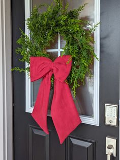 a red bow hangs on the front door