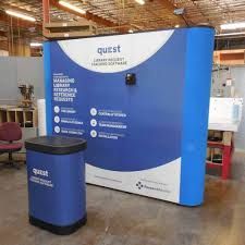 a large blue and white booth with two trash cans