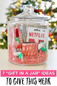 a jar filled with candy and candies next to a christmas tree