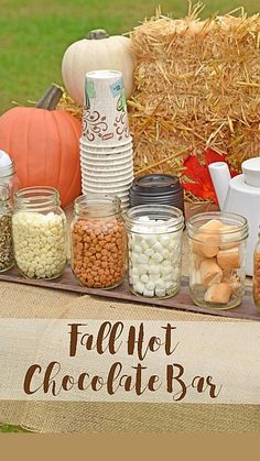 a table topped with jars filled with different types of candy and marshmallows