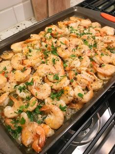 a pan filled with shrimp on top of a stove