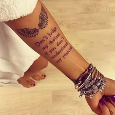 a woman's arm with a tattoo that says don't judge my body