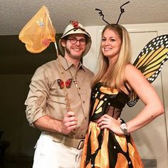 a man and woman dressed up in costumes posing for the camera with butterfly wings on their heads