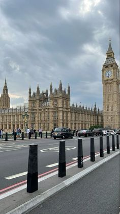 the big ben clock tower towering over the city of london on a cloudy day in england