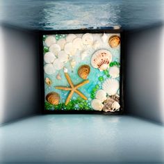 there are shells and starfishs in the water on this tile wall art piece