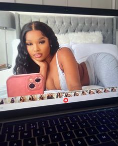 an open laptop computer showing a photo of a woman on the bed with her instagram