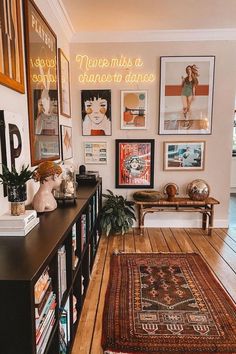 a living room filled with lots of pictures on the wall next to a wooden floor