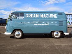 an old blue van parked in a parking lot with the words dream machine on it