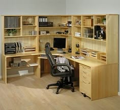 an office with a desk, chair and bookshelf in the middle of it