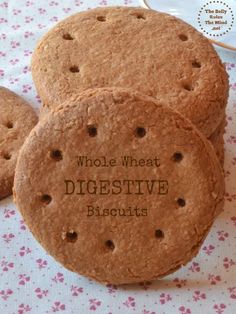 three cookies with words on them sitting on a table