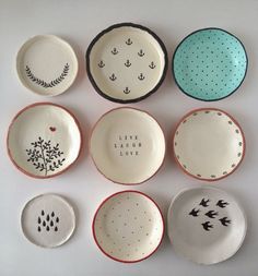 nine plates with different designs and words on them